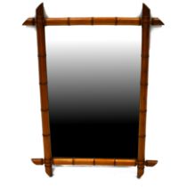 A turn of the Century bamboo framed mirror, the glass measuring 46cm x 70cm, overall maxima 91cm ...
