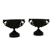 A pair of 19th Century Grand Tour bronze two handled drinking cups mounted on round marble socles...