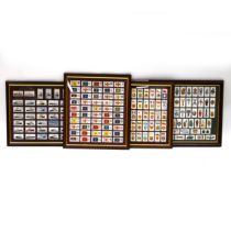 Four framed sets of cigarette cards, all frames with glass backs (4). Wills- Lucky Charms; Player...