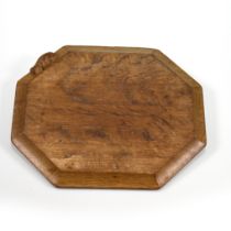 An eight sided carved oak chopping board bearing the Robert "Mouseman" Thompson mouse to the side...