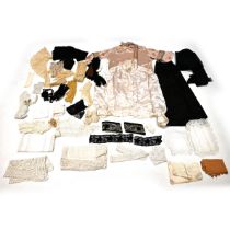 A quantity of 19th century and later textiles including a pink blouse with chain stitching, a cre...