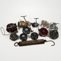 A collection of eleven fishing reels to include Fjord, "The Gordon" by Sharpes of Aberdeen, Alvey...