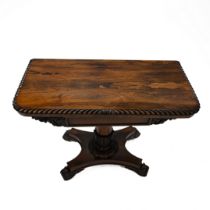 A William IV rosewood folding card table with carved scrolled edge with acanthus leaf details to ...