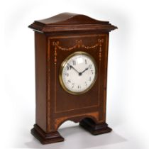A neat mahogany cased mantle clock, circa 1900, inlaid with fruitwood swags, of unusual footed fo...