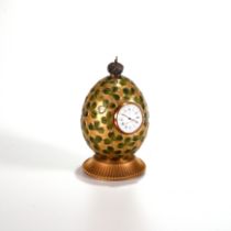 A modern gilt metal and enamel clover Egg time piece by Theo Faberge, England, No. 254 of 750. Th...