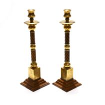 A pair of oriental brass, copper and bakelite candlesticks 39cm tall.