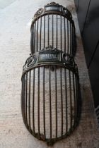 A large pair of ornate cast iron hay racks or mangers dating from the 19th Century, one bearing t...
