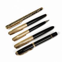 A collection of five writing instruments including a Parker fountain pen with 14k gold nib, the t...