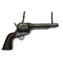 A large carved and painted wooden advertising six shooter pistol bearing the name "E.M.Reilly New...