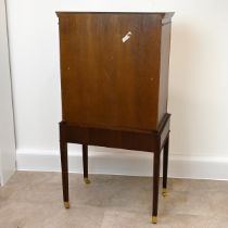 Mid 20th Century mahogany cocktail cabinet with two panelled doors, opening to reveal a mirror-ba...