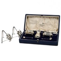 A silver three piece cruet set, along with a pair of silver miniature easel frames, 134 grams