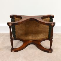 A Saddle style footstool, in the manner of Chesterfield, with buttoned green leather top and maho...