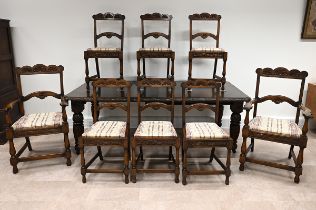 Late Victorian carved oak extending dining table and eight chairs. The table with carved edge and...