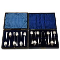 A silver set of matching teaspoons and matching sugar nips, along with a set of silver teaspoons ...