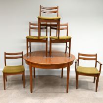 1970's circular teak dining table with fold out extension leaf  plus 5 chairs (one a carver) with...