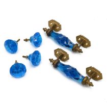 A set of brass and faceted glass handles and matching door knobs