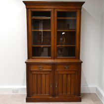 Edwardian glazed oak bookcase, the upper part a stepped pediment over  two glazed doors, with bra...
