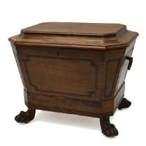 A Regency (circa 1820) mahogany wine cooler. Of sarcophagus shape with brass laurel wreath ring h...