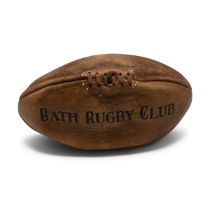 A leather rugby ball, printed "Bath Rugby Club"