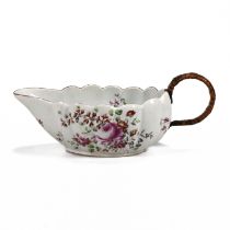A Derby sauceboat, circa 1760, with scalloped rim, fluted sides, floral decoration to bowl's inne...