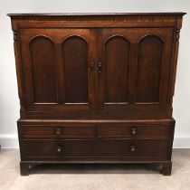 19th Century Oak Linen Press Cupboard comprising two doors, flanked by turned and facetted column...