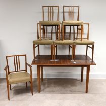 A Mid-Century Gordon Russell for Heals teak extending dining table and 6 chairs (one of which is ...