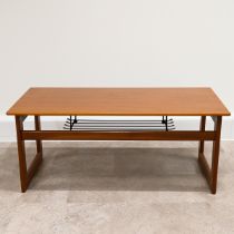 Mid Century teak coffee table of rectangular form with wire magazine tray under raised on square ...