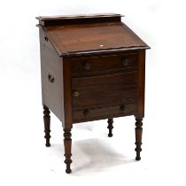 A Victorian mahogany washstand with sloping top opening to reveal recesses for wash bowl and a br...