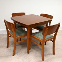 Mid Century Teak dining table and four chairs. The draw-leaf extending table of rounded square fo...