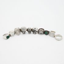A collection 11 various silver rings, including a silver jubilee example, various skull designs a...
