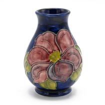 Moorcroft - mid 20th Century blue ground posy vase with Clematis pattern. Impressed mark. Height ...