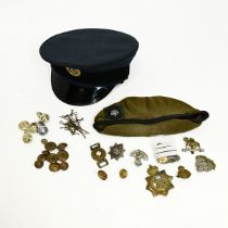 Collection of military badges, buttons, along with a R.A.F cap and a Yorkshire beret