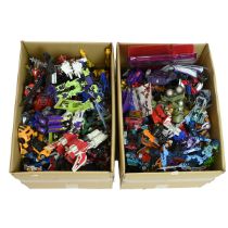 A large collection of vintage and modern Transformers figures and accessories