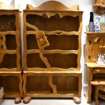A late 20th Century character oak bookcase, with carved eyes and booted feet. H 197cm, W 112cm, D...