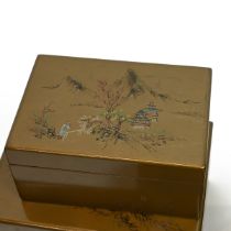 A carved Chinese teak model of a buddha with a reptile, along with set of lacquered boxes