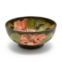 Moorcroft coral Hibiscus pattern bowl with green ground. Circa 1950's with paper W Moorcroft labe...