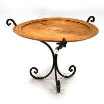A Mid Century hand wrought iron based coffee table with turned elm top c1950s. Diameter 88cm, H 5...