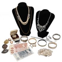 A colleciton of costume jewellery including a silver bangle, cameo brooches, various coins and ot...