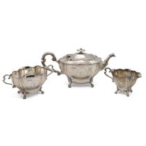 An Edwardian silver three piece tea set, the shaped teapot handle with ivory insulators with each...