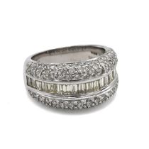 An 18k white gold and diamond ring, eighteen baguette cut diamonds, flanked by ninety-eight round...
