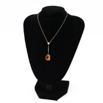 A 9ct yellow gold paste and pearl pendant necklace, set with Citrine coloured glass and a single ...