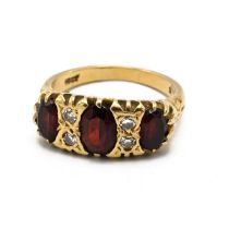 A 18ct gold diamond and three stone garnet gypsy ring, stamped "18ct", finger size M, 5.40 grams.(J)