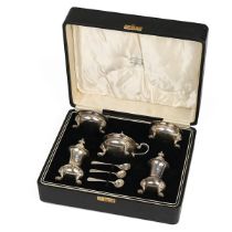 A George V five piece silver cruet set, comprising a two salts, mustard pot, two peppers and thre...