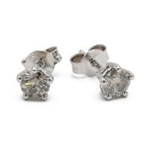 A pair of 18k white gold and diamond stud earrings, set with two round brilliant cut diamonds, to...