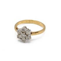 An 18ct yellow gold and diamond flowerhead cluster ring, set with seven round brilliant cut diamo...