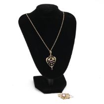 A 9ct gold Art Nouveau pendant of heart shaped form, set with single oval amethyst and seed pearl...