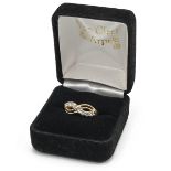 A 14ct gold and diamond twist ring set with eight brilliant cut diamonds, weighing approximately ...