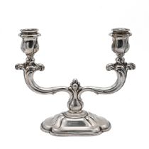 A continental silver two section candlestick, of stylised form, 20cm high, stamped "830", 462 gra...