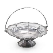 An Edwardian silver pierced cake basket, with swing handle and rasied on shaped pederstal base, S...