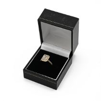 An 18k yellow gold and diamond ring, set with a mixed step cut diamond, approximately 7.88x5.47mm...